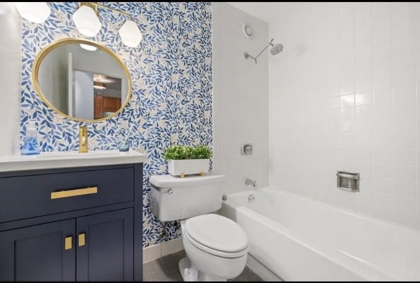 Updated bathroom vanity with mirror and wood cabinet