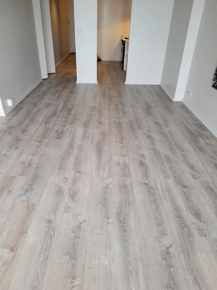 Finished room with new gray walls and vinyl plank floor